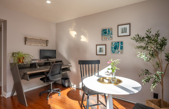 Dedicated workspace with natural light and a small dining nook, ideal for remote work and casual meals. A practical, comfortable setup that supports everyday living and productivity.