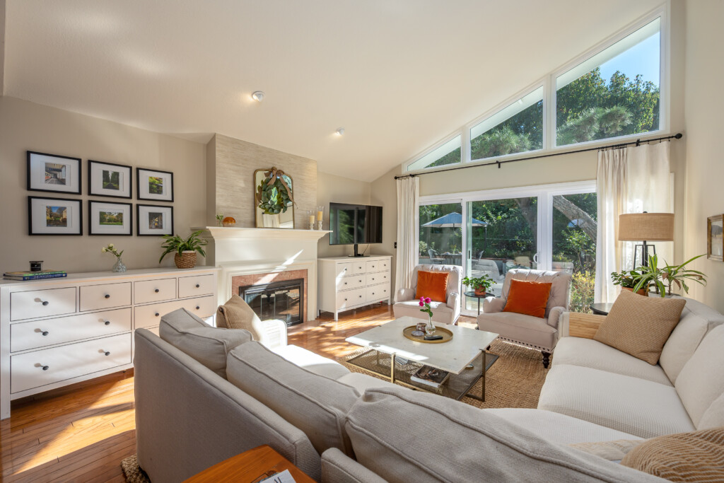Sun-filled living space with cozy seating, a fireplace, and seamless indoor-outdoor flow through large garden-facing windows. Perfect for longer stays in Diamond Bar, offering a calm place to relax, work, and settle into daily life.