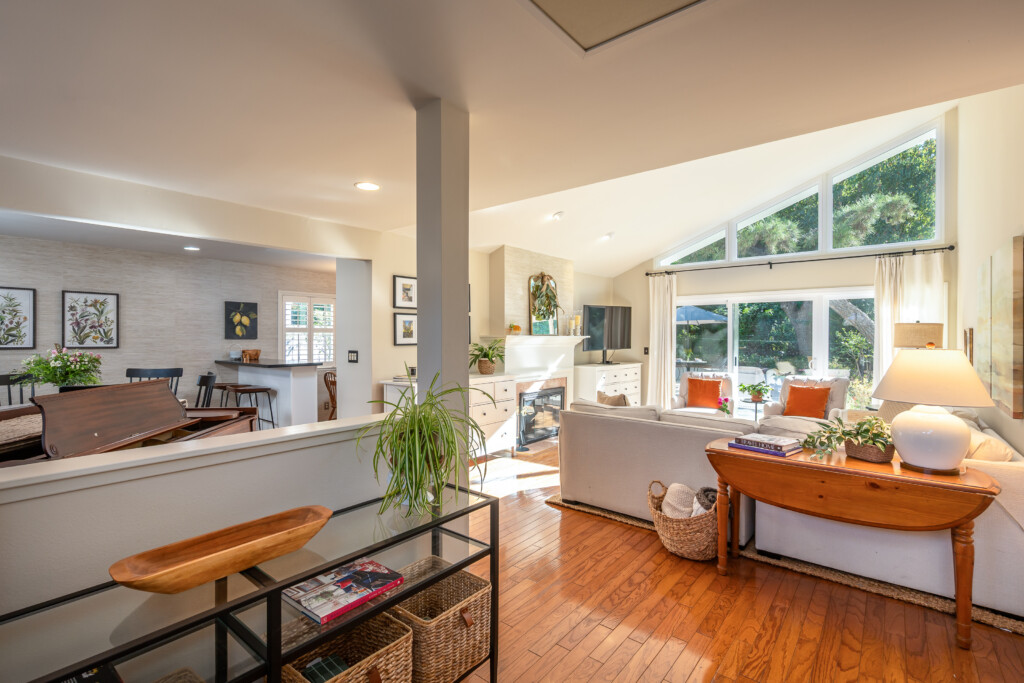 Spacious open-concept living area with soaring ceilings and abundant natural light. Seamless flow between living, dining, and kitchen spaces. Perfect for everyday comfort and easy entertaining.