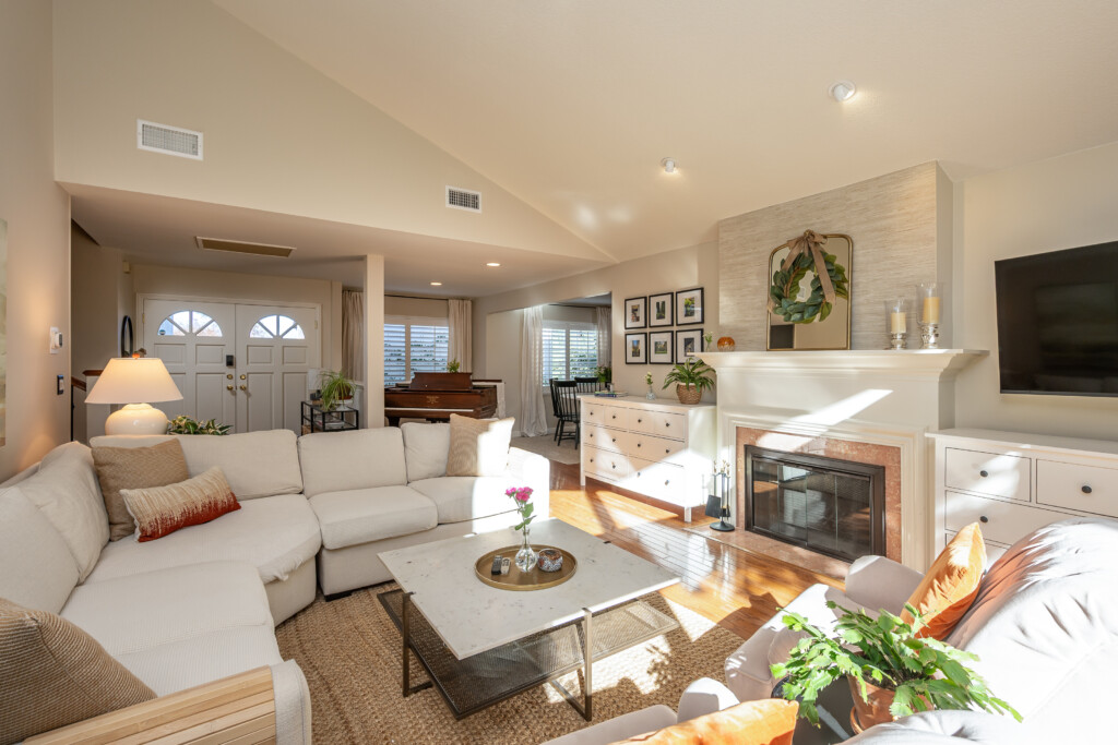 Warm, inviting living area with a cozy fireplace, comfortable seating, and an open connection to the rest of the home. An ideal space to relax, gather, or unwind after a full day.