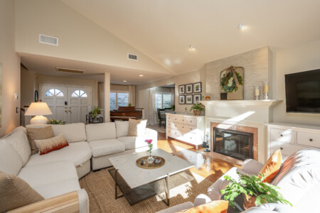 Warm, inviting living area with a cozy fireplace, comfortable seating, and an open connection to the rest of the home. An ideal space to relax, gather, or unwind after a full day.