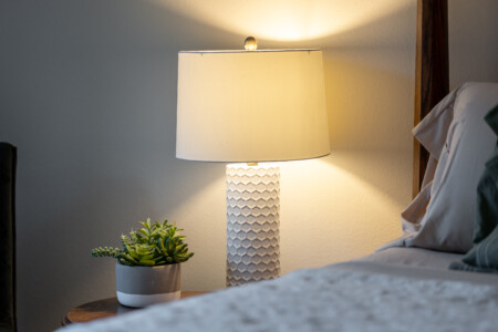Soft bedside lighting and simple, calming details create a cozy, restful atmosphere. Thoughtfully styled for relaxed evenings and comfortable nights.