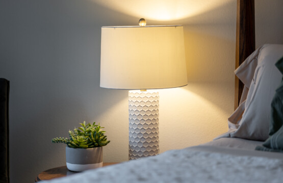 Soft bedside lighting and simple, calming details create a cozy, restful atmosphere. Thoughtfully styled for relaxed evenings and comfortable nights.