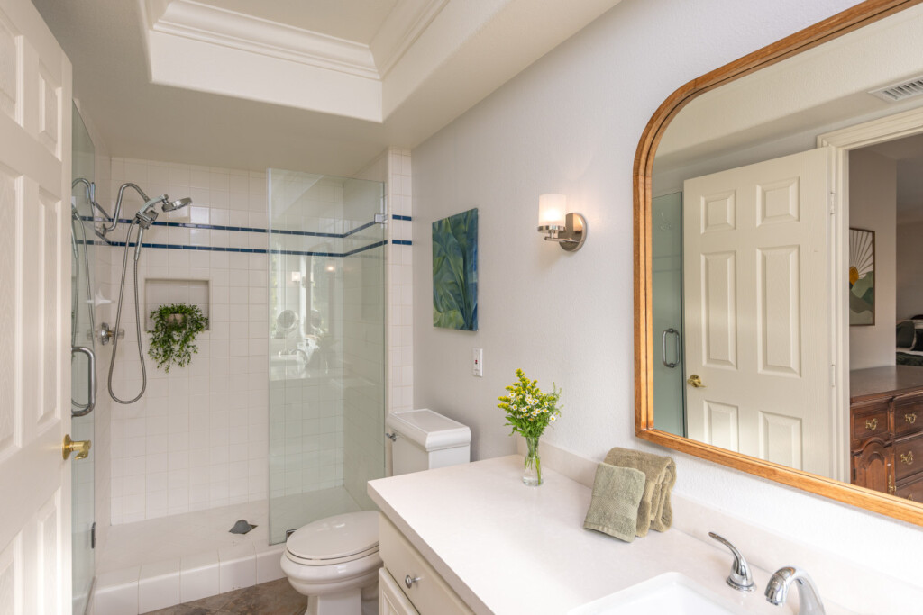 Bright, spa-inspired bathroom with a glass walk-in shower and generous vanity space for daily routines. A comfortable, easy-to-use space designed for relaxed, longer stays.