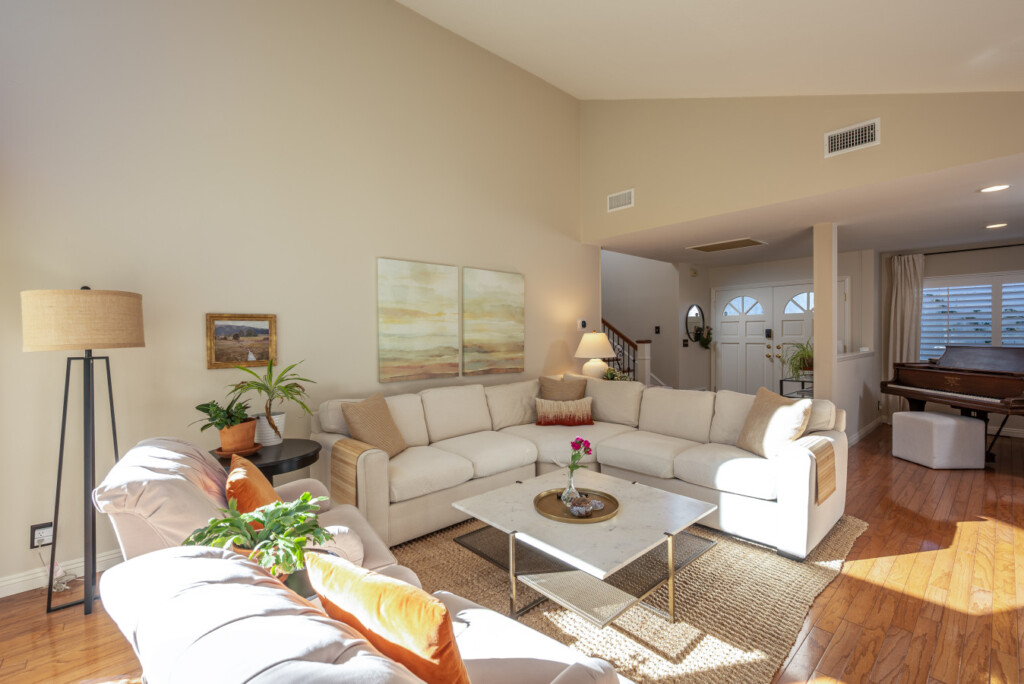 Light-filled living room with soaring ceilings and large windows that bring the outdoors in. A relaxing space to settle into daily routines, ideal for longer stays in a quiet Diamond Bar neighborhood.