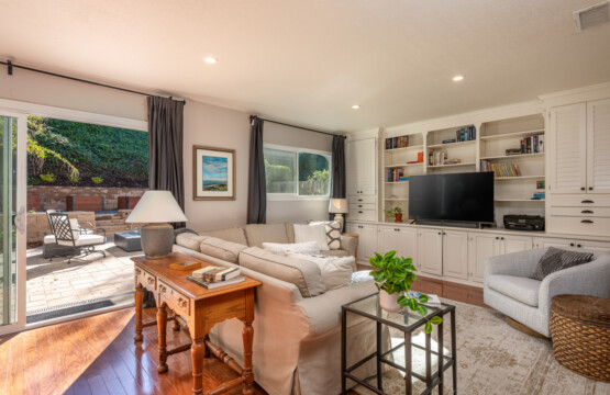 Comfortable lounge space with built-in shelving, TV, and easy access to the outdoor patio for seamless indoor-outdoor living. Perfect for relaxing evenings, movie time, or casual work-from-home days.