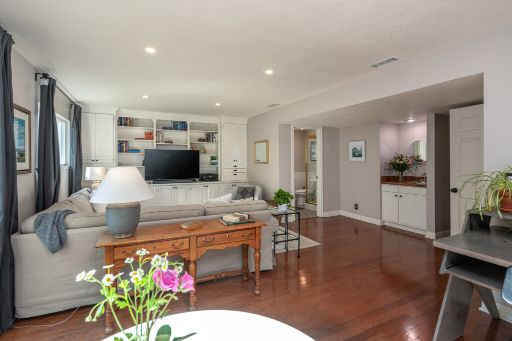 Spacious secondary living area with built-in shelving and TV, perfect for movie nights, quiet reading, or extended-stay downtime. An ideal bonus space for remote workers or families staying longer in Diamond Bar.