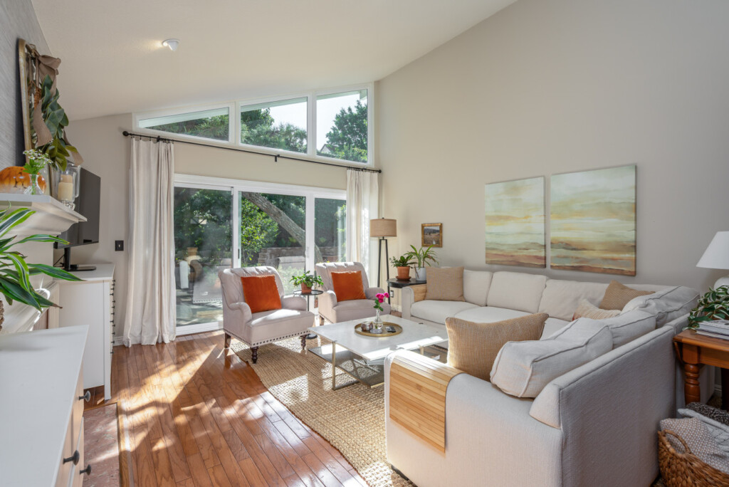 Light-filled living room with soaring ceilings and large windows that bring the outdoors in. A relaxing space to settle into daily routines, ideal for longer stays in a quiet Diamond Bar neighborhood.