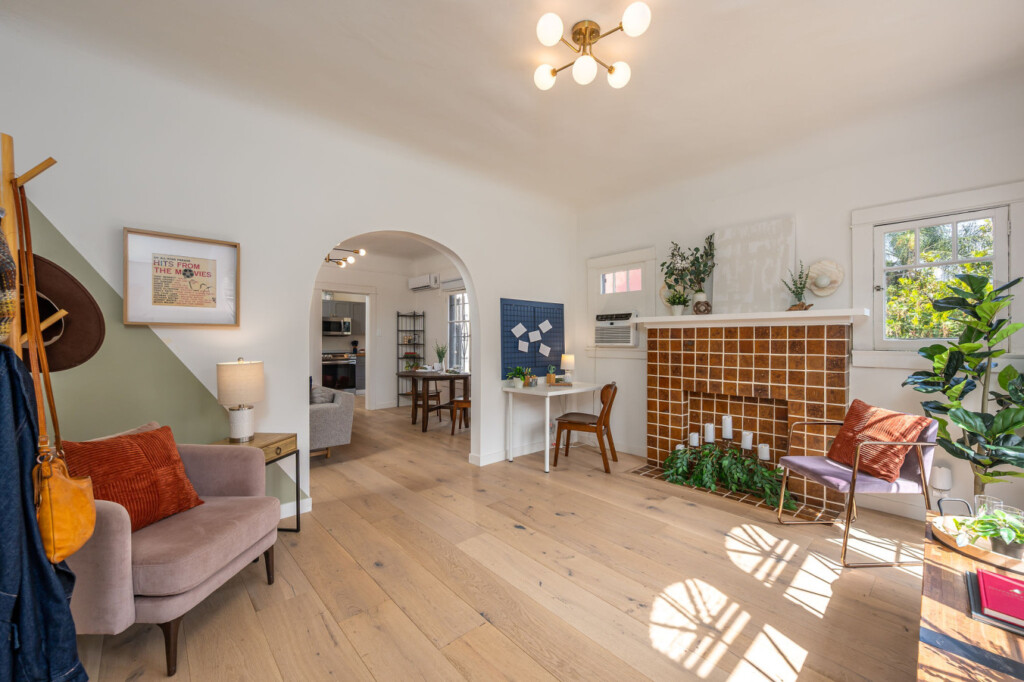 A bright, thoughtfully designed living area with original tilework and a dedicated workspace tucked to the side. With natural light, greenery, and room to focus or unwind, it’s ideal for comfortable longer stays.