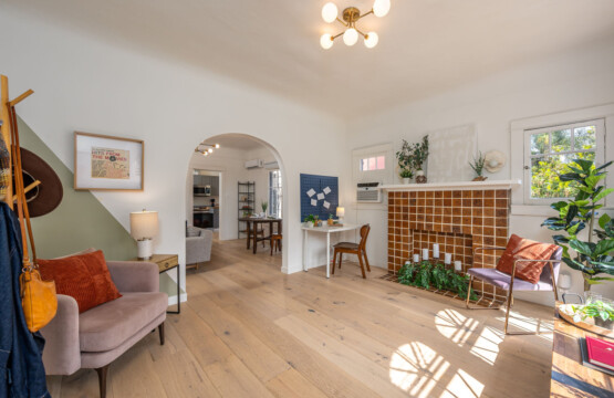 A bright, thoughtfully designed living area with original tilework and a dedicated workspace tucked to the side. With natural light, greenery, and room to focus or unwind, it’s ideal for comfortable longer stays.