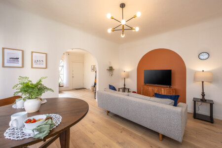 A welcoming living room anchored by a custom arched nook and soft, comfortable seating. Thoughtfully designed for both relaxing evenings and longer stays, with space to unwind and feel at home.