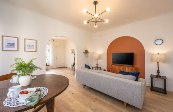 A welcoming living room anchored by a custom arched nook and soft, comfortable seating. Thoughtfully designed for both relaxing evenings and longer stays, with space to unwind and feel at home.