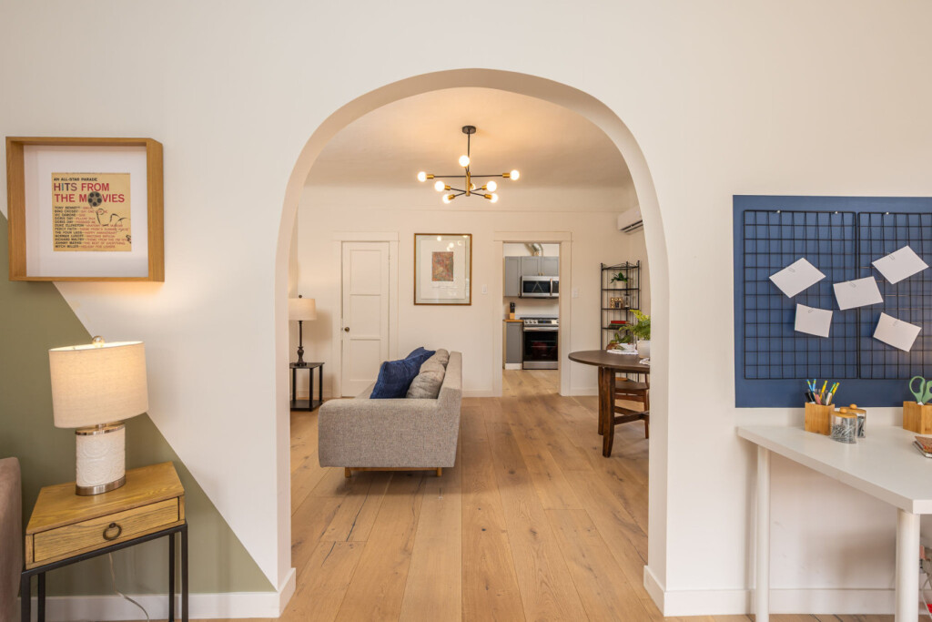 A classic arched passageway leads you through the home, blending its 1925 character with a clean, modern flow. From living to dining and kitchen, each space connects with ease for comfortable, everyday living.