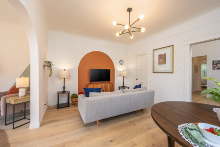 A welcoming living room anchored by a custom arched nook and soft, comfortable seating. Thoughtfully designed for both relaxing evenings and longer stays, with space to unwind and feel at home.