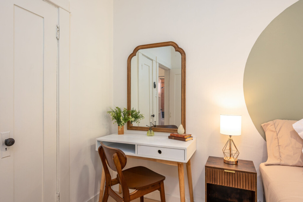 A quiet vanity corner with warm wood accents and soft lighting, perfect for getting ready or easing into your day. Thoughtfully placed to feel both private and connected within the home.