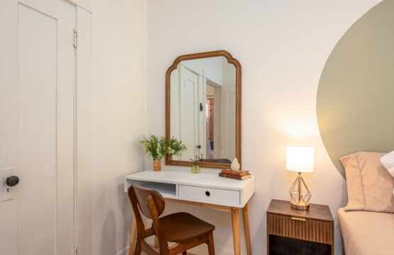 A quiet vanity corner with warm wood accents and soft lighting, perfect for getting ready or easing into your day. Thoughtfully placed to feel both private and connected within the home.