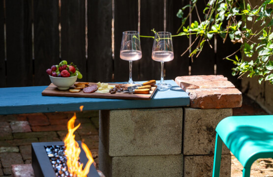 A private brick courtyard with a built-in fire pit, perfect for relaxed evenings under the string lights. Surrounded by greenery, it’s an inviting outdoor space that feels like your own hidden retreat.