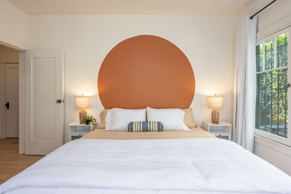 A calm, inviting bedroom with a warm statement wall and soft lighting for restful nights. Designed for comfort and ease, it’s a space you’ll look forward to coming home to each day.